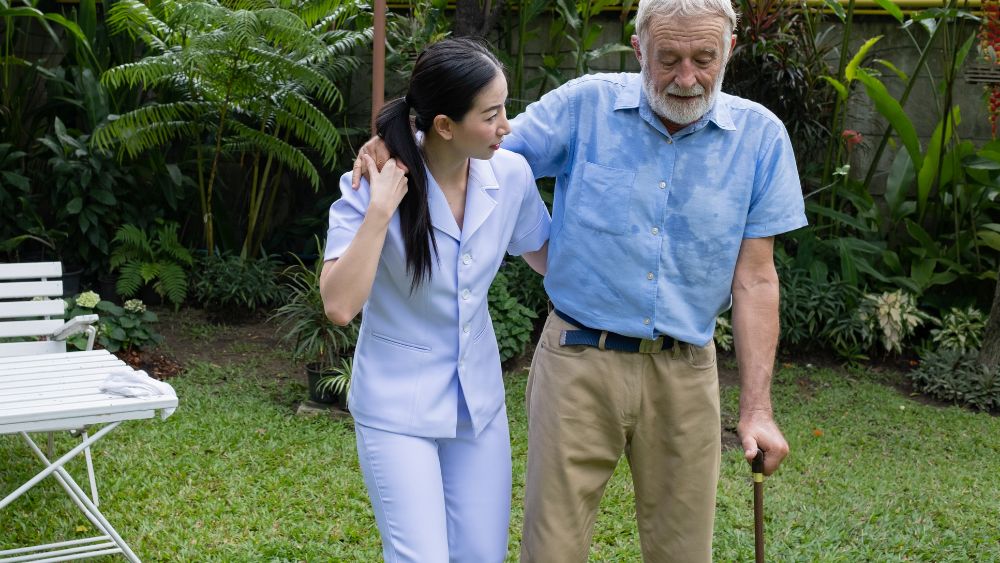 Caregiver Helping Elderly Person - Shanti Mindcare Blog
